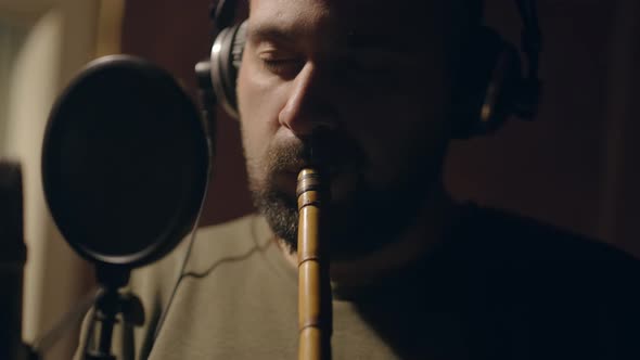 Man Playing a Flute in Studio