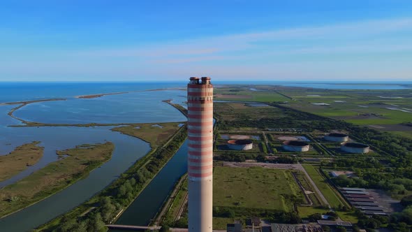 Aerial view of old thermoelectric plant with big chimne in a rural landscape