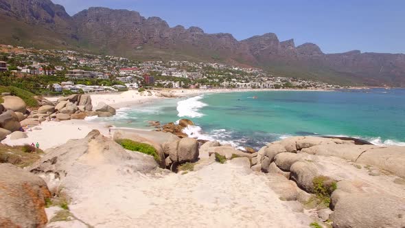 Aerial travel drone view of Camps Bay beach, Cape Town, South Africa.