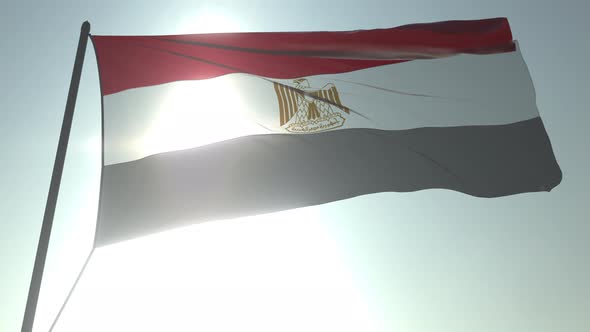 Waving Flag of Egypt Against Shining Sun and Sky