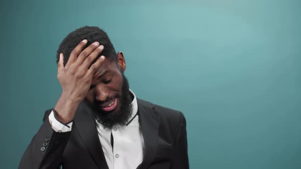 A Handsome African Man in a Tuxedo Has Some Problems and He Tries to Find a Solution of It