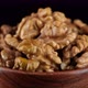 Walnuts in wooden bowl, rotation. Healthy vegan food concept - VideoHive Item for Sale