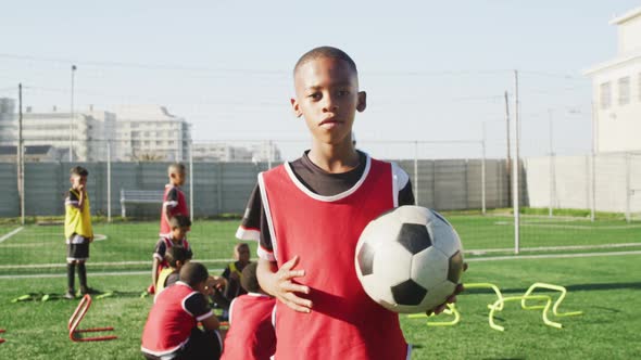 African American soccer kid exercising in a sunny day