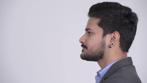 Profile View of Young Bearded Indian Businessman Wearing Suit