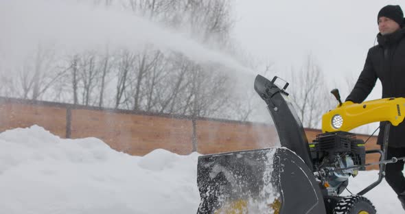 Man Working with Manual Snow Blower