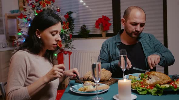 Man and Woman Clinking Glasses of Champagne at Festive Dinner