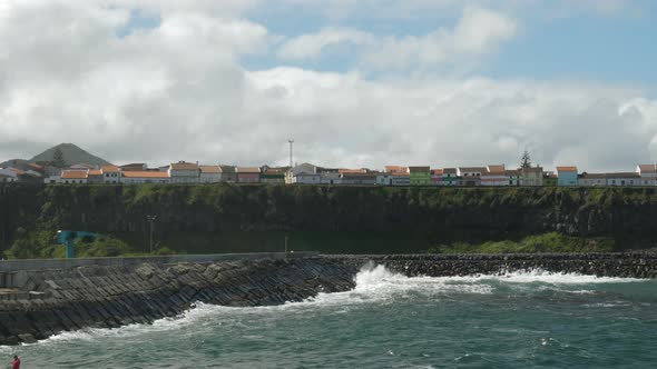 Waves crashing into an harbor in Azores