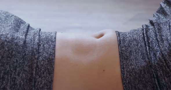 Extreme Close-up of Woman Doing Abdominal Exercise