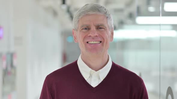 Cheerful Middle Aged Man Smiling at Camera