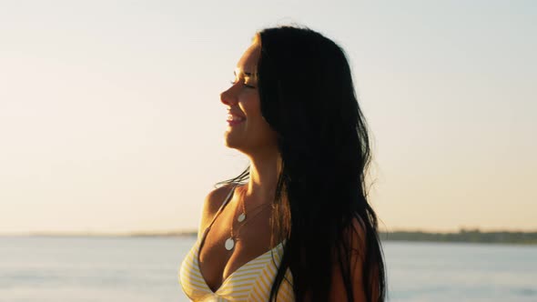 Smiling Young Woman in Bikini Swimsuit on Beach