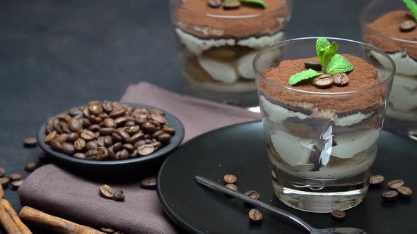 Classic Tiramisu Dessert in a Glass on Dark Concrete Background