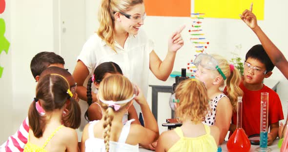 Teacher assisting kids in laboratory