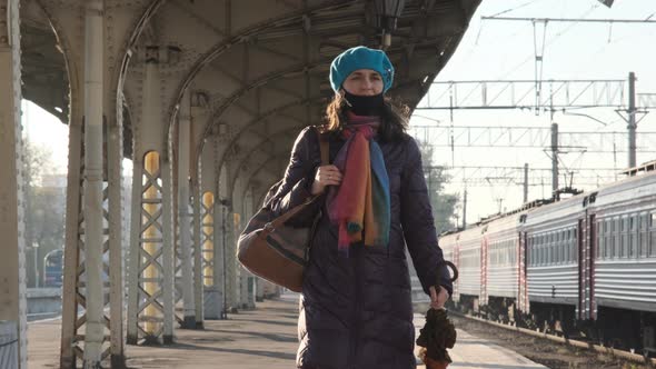 Woman in Face Mask Walks Along Railway Platform