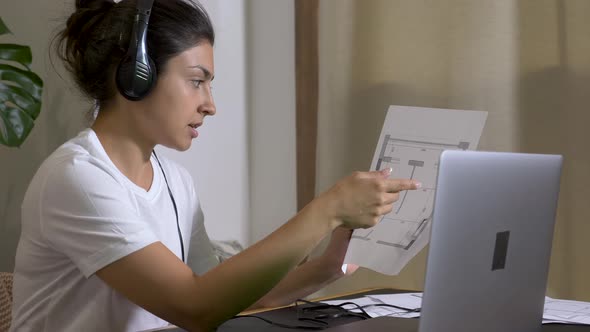 female Indian architect during meeting in an office using laptop computer online