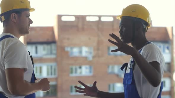 Co-workers Talking at Construction Site