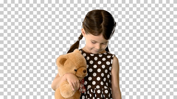 Shy little girl in polka dot dress hugging, Alpha Channel