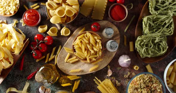 Assortment Different Types Dry Pasta on Table Slowly Rotates 