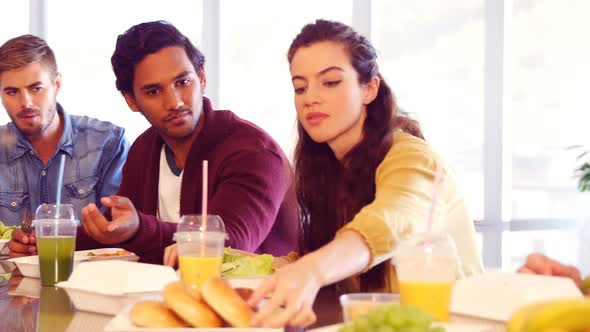 Business colleagues having meal in cafeteria