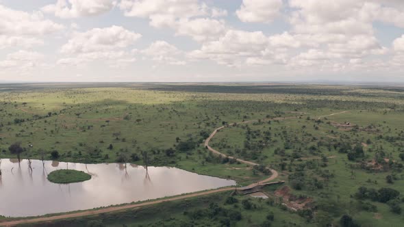 Waterhole lake in Laikipia, Kenya. High aerial drone view of Kenyan landscape