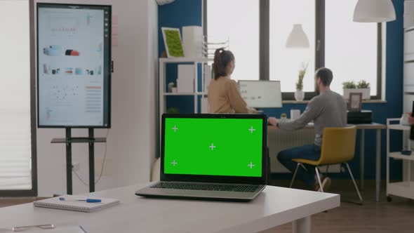 Close Up of Laptop with Green Screen at Empty Desk