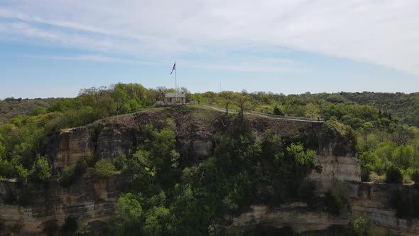 Grandad's Bluff in La Crosse, Wisconsin. Blue sky with wispy clouds. Levels of stone seen.