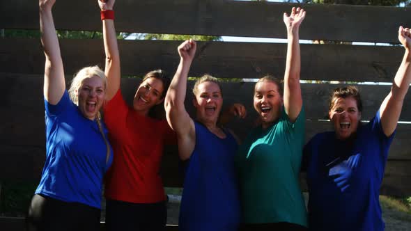 Portrait of happy women cheering during obstacle course