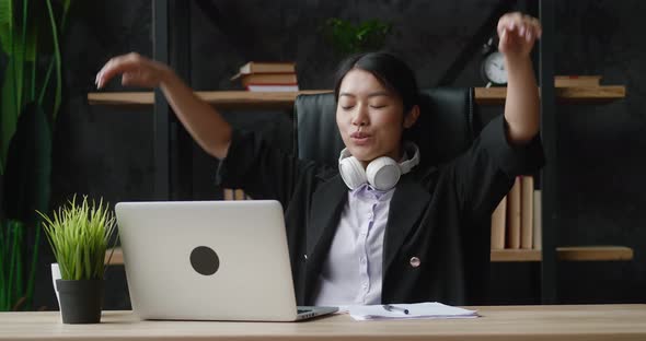 Young Asian Business Woman Relax Sit at Office Desk Finished Laptop Computer Work Feel Satisfied