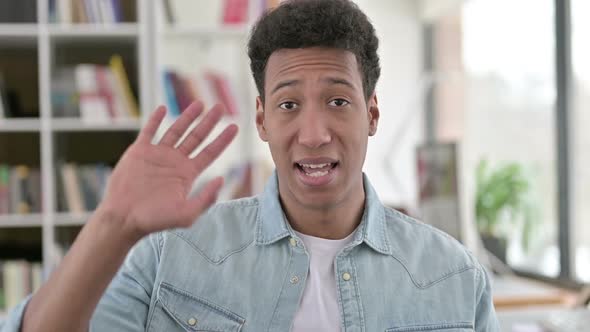 Delighted Young African American Man Waving Saying Hello