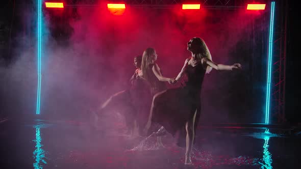 Contemporary Choreography Performed By a Group of Young Women. Females Dance on a Smoky Background