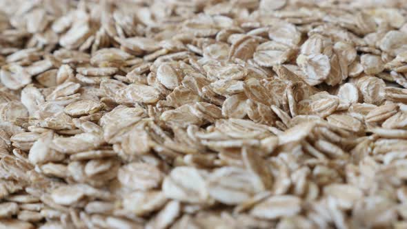 Pile of dehydrated rye flakes close-up 4K 2160p 30fps UltraHD panning  footage - Healthy food made o