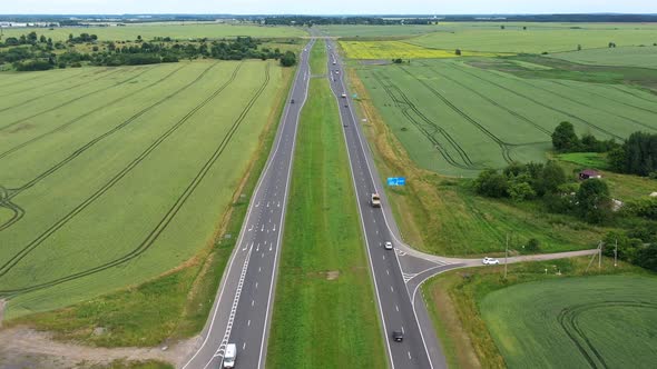 Asphalt Highway Through Green Summer Field