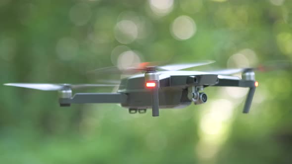 Drone Copter with Blurred Propellers and Video Camera Flying in Air