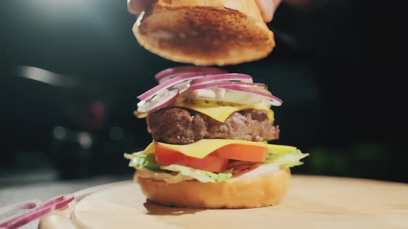 Hands Of Chef Making Burger. Slow Motion