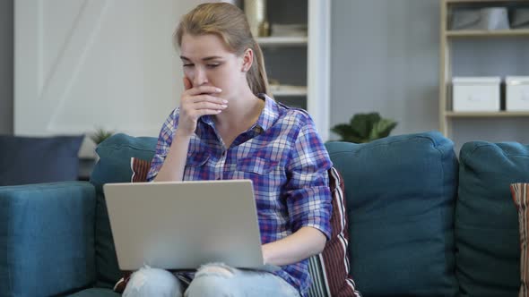 Sick Casual Woman Coughing while Using Laptop