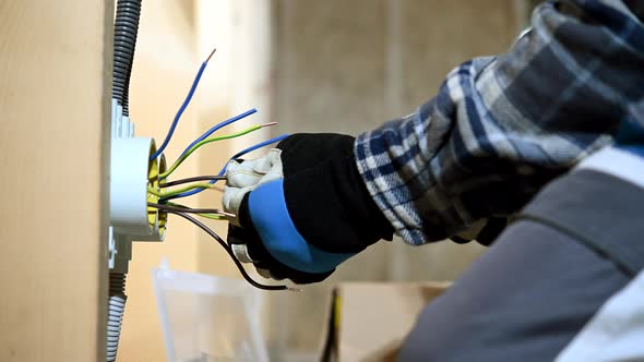 Worker Preparing Wires For Electric Plug Installation.