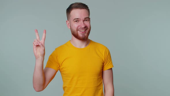 Handsome Joyful Smiling Man Showing Victory Sign Hoping for Success and Win Doing Peace Gesture