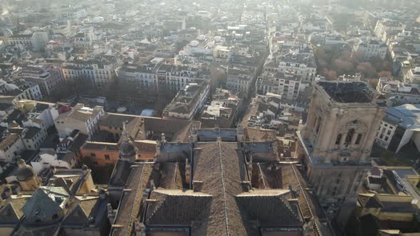 Aerial pullback over the historic Granada Cathedral; golden hour light