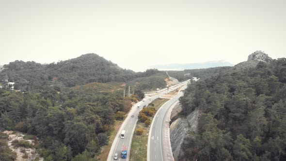 Multi-lane speedy highway with lot of cars moving fast on asphalt road.