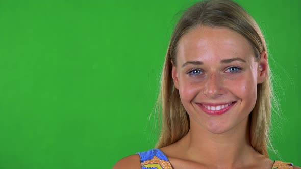 Young Pretty Blond Woman Smiles To Camera - Green Screen - Studio
