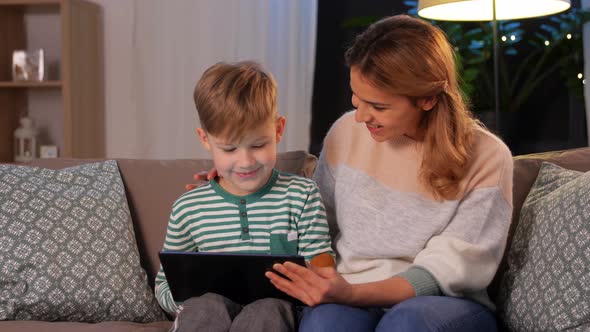 Mother and Son Using Tablet Computer at Home