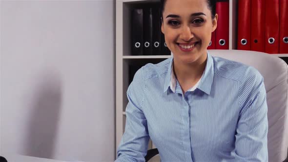Happy Businesswoman Smiling at Camera in Office
