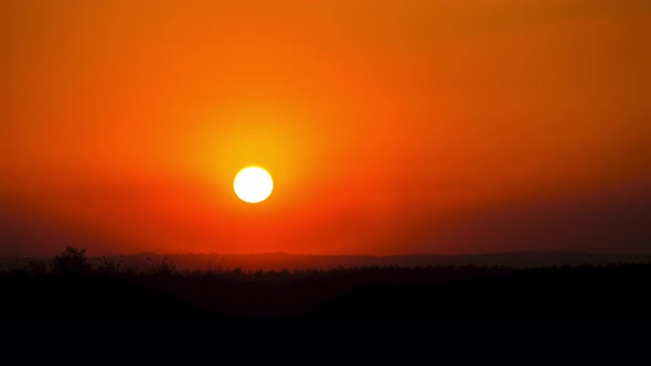 Timelapse Sunset in the Sky Big Bright Yellow Sun Moves Down on the Horizon