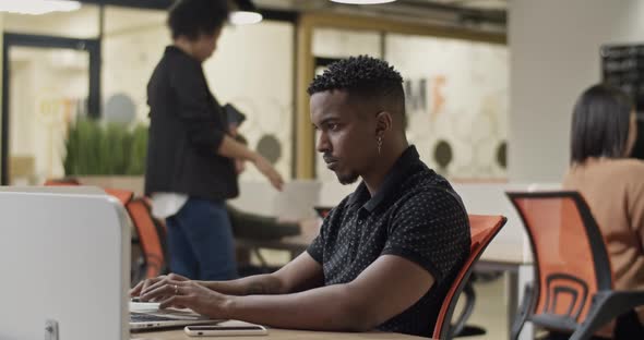 Black Man Using Laptop During Inspection