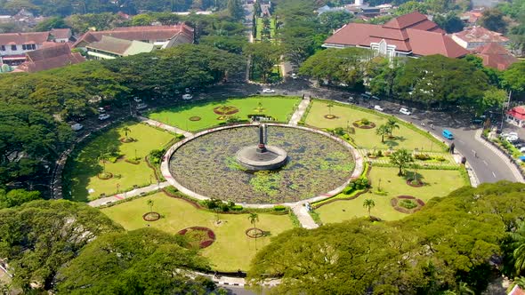 Roundabout with park and lily pond in front of Malang city hall Indonesia aerial