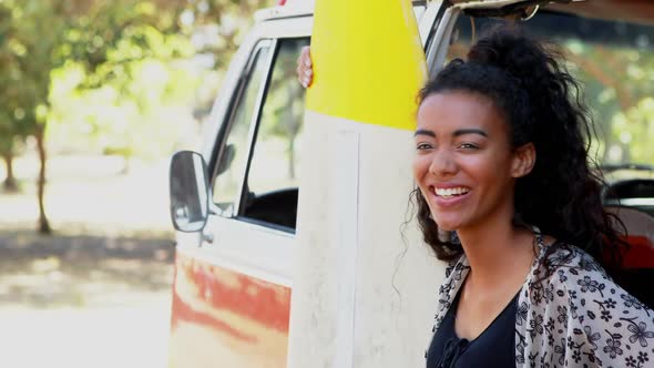 Woman leaning on camper van in the park 4k