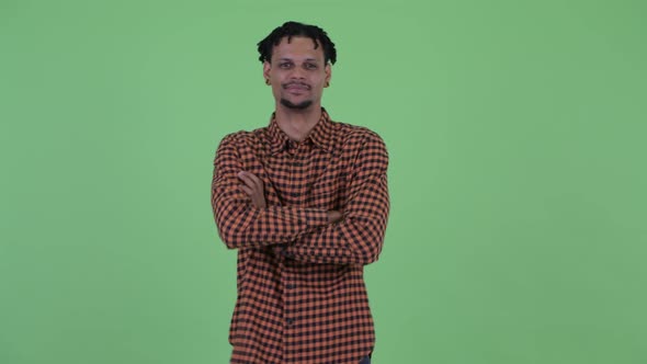 Happy Young Handsome African Man Smiling with Arms Crossed