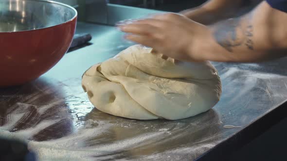 Professional Baker Preparing Dough Working at the Kitchen