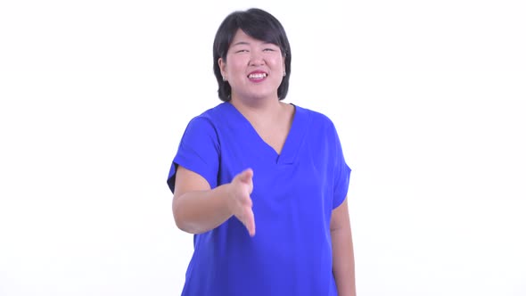 Happy Overweight Asian Businesswoman Giving Handshake