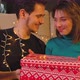 Beautiful Young Couple Opening a Gift Box and Smiling with Christmas Decoration - VideoHive Item for Sale