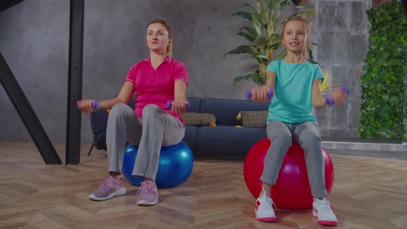 Active Fit Mom and Child Exercising Dumbbell Bicep Curls